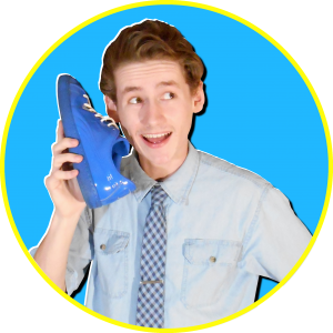 drew blue holds shoe to face like a phone